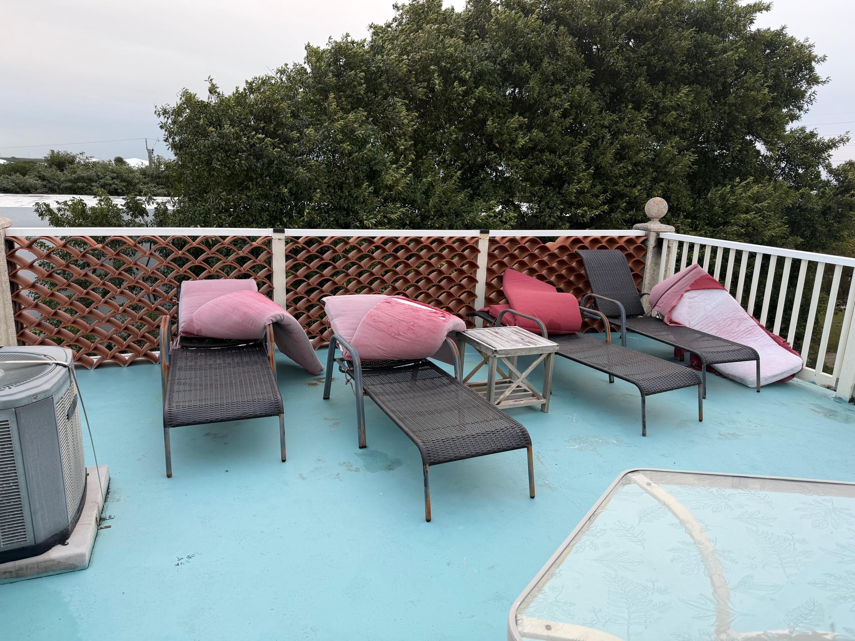 Faded, Dirty, Ripped Cushions on Rooftop