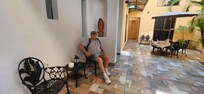 Jim sitting in a nice little sitting area outside of our room.