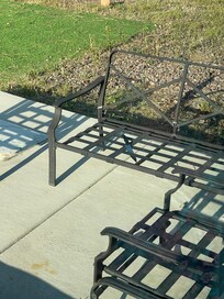 Large kitchen knife on patio chair. All metal furniture had no cushions.