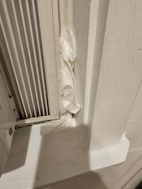 Paper towel stuffed around ac unit