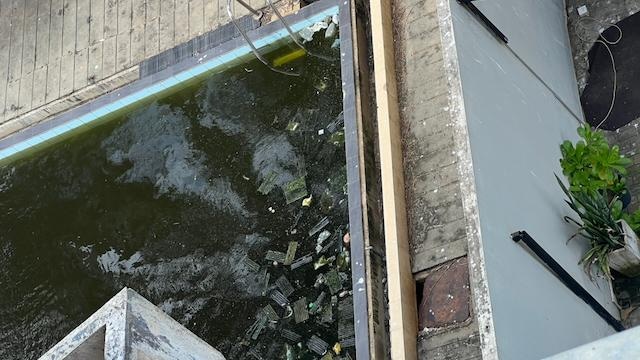 Stagnant pool in adjacent building with putrid water