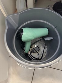 Bathroom drawer . Who puts hair dryer in bucket under the cabinet?