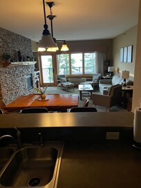 Looking through kitchen, living rm to view.