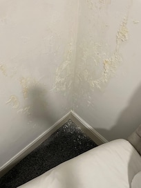 Peeling/flaking wallpaper near headboards