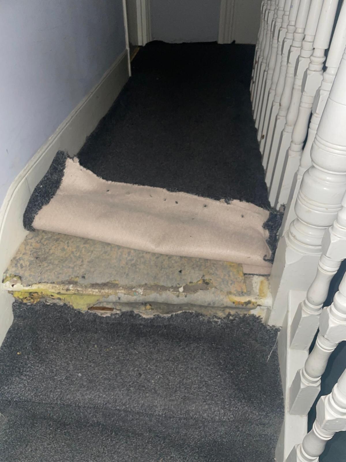 One of the trip hazard carpets in hallway outside room 3.