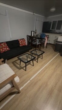 Living room and kitchen area. Spacious, open, clean and the kitchen has many useful items and utensils. Toaster oven microwave and more.