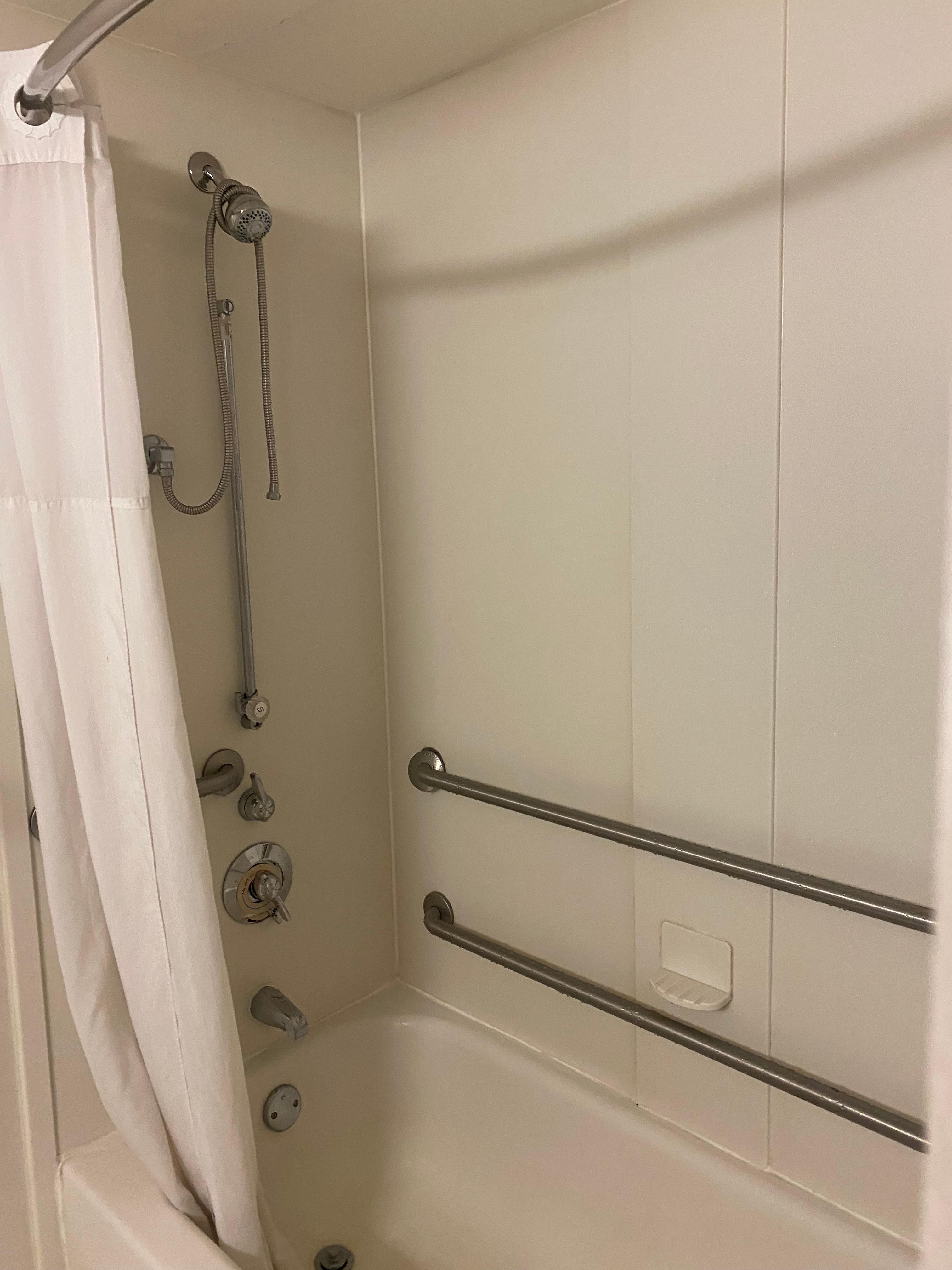 Note shower attachment hanging not attached. 
