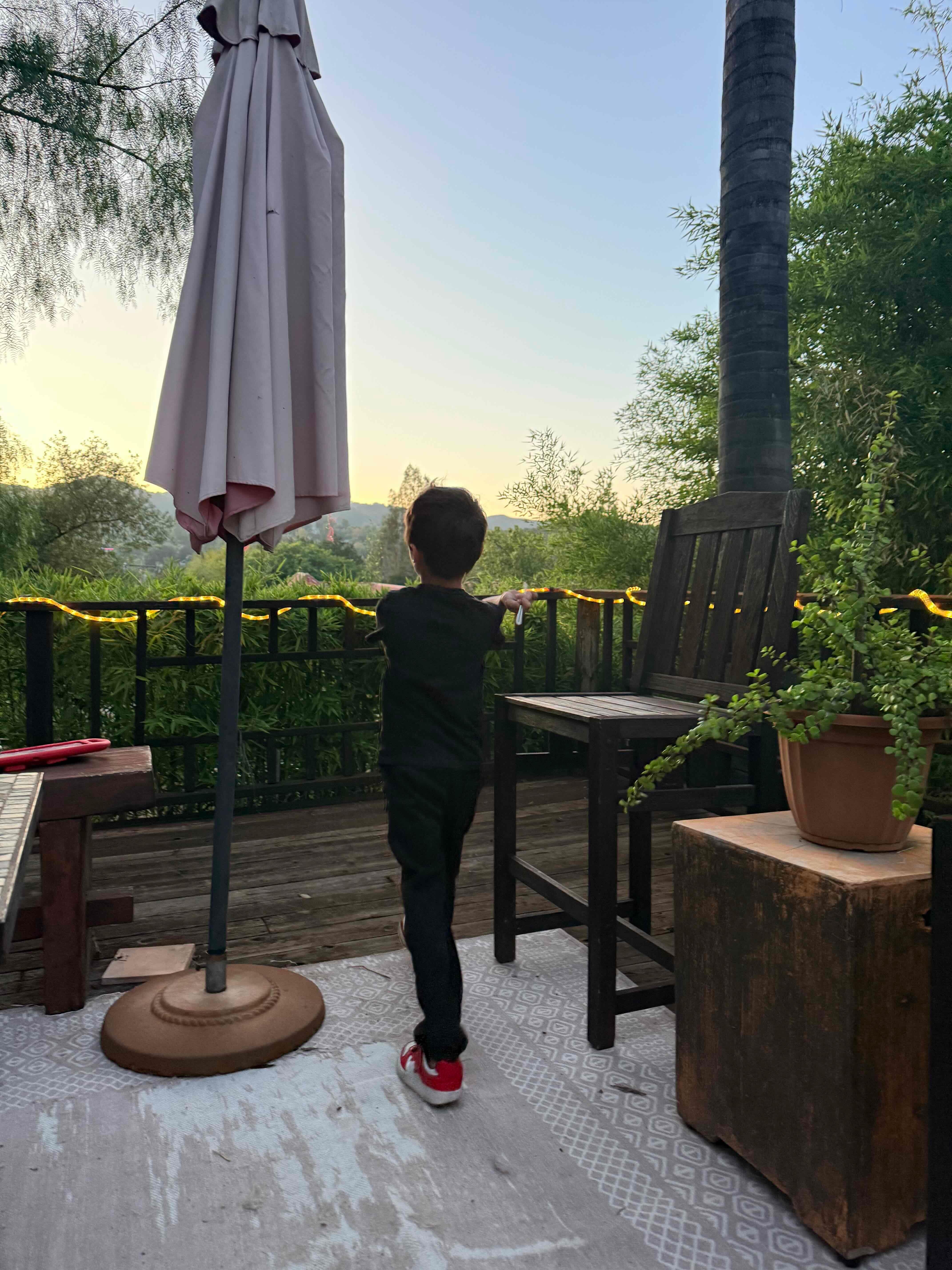 Child enjoying sunset from the deck
