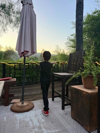 Child enjoying sunset from the deck