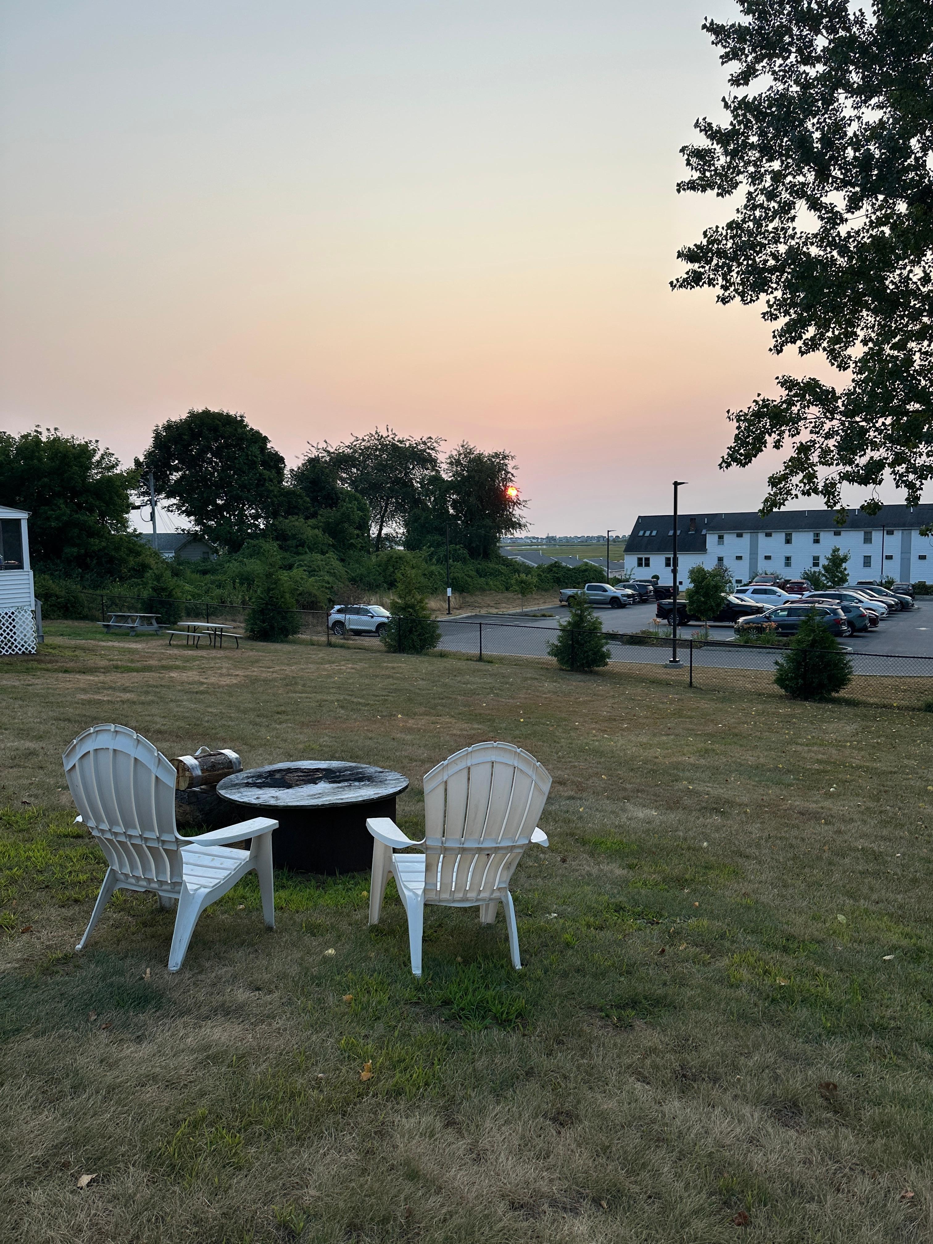 Sunrise views from the cabin over the chairs and firepit available for our use