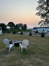 Sunrise views from the cabin over the chairs and firepit available for our use