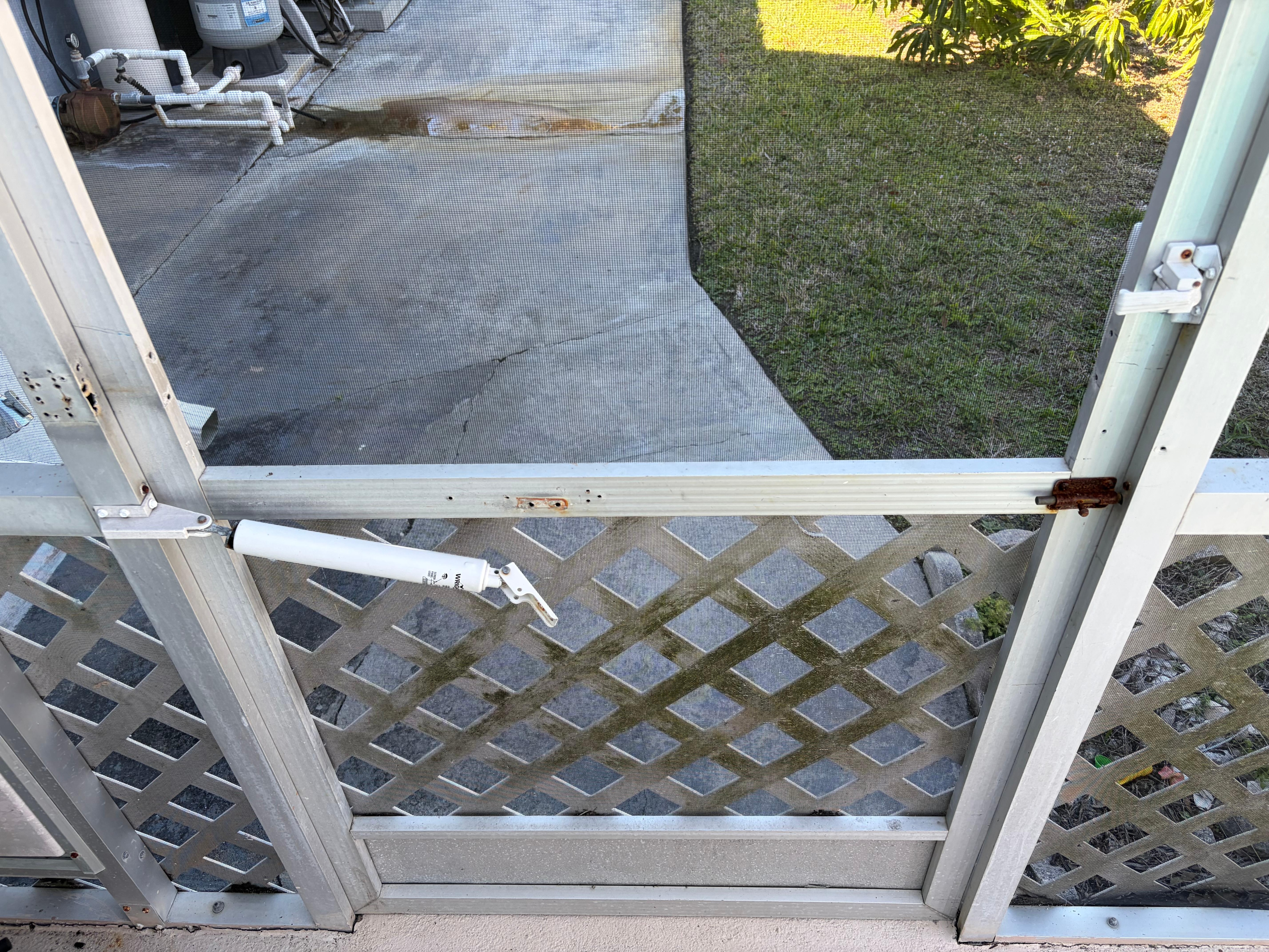 Broken screens and door on pool bird cage