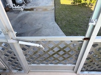 Broken screens and door on pool bird cage