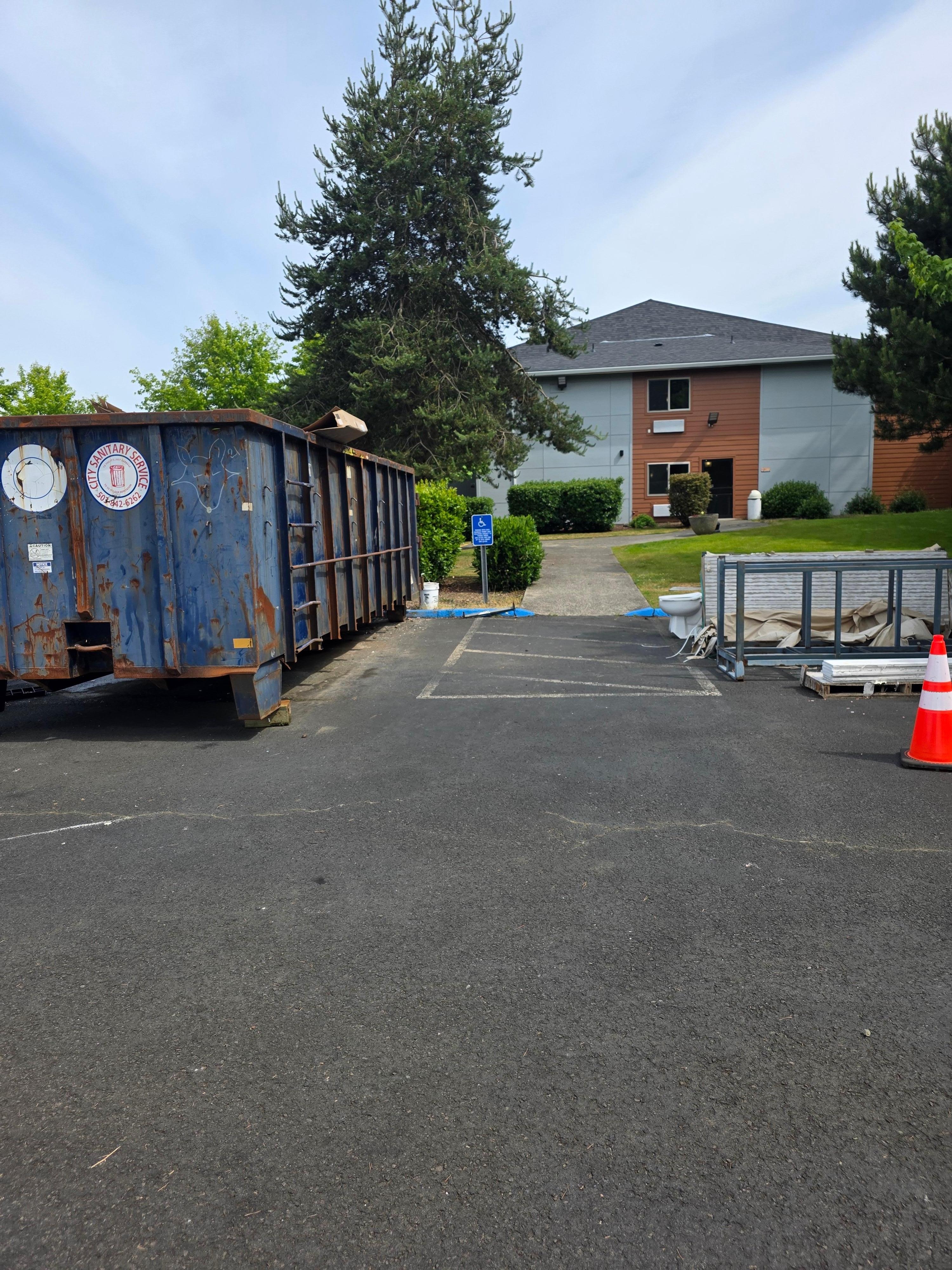 Dumpster in handicapped parking that's accessible with rolling suitcases/mobility scooters