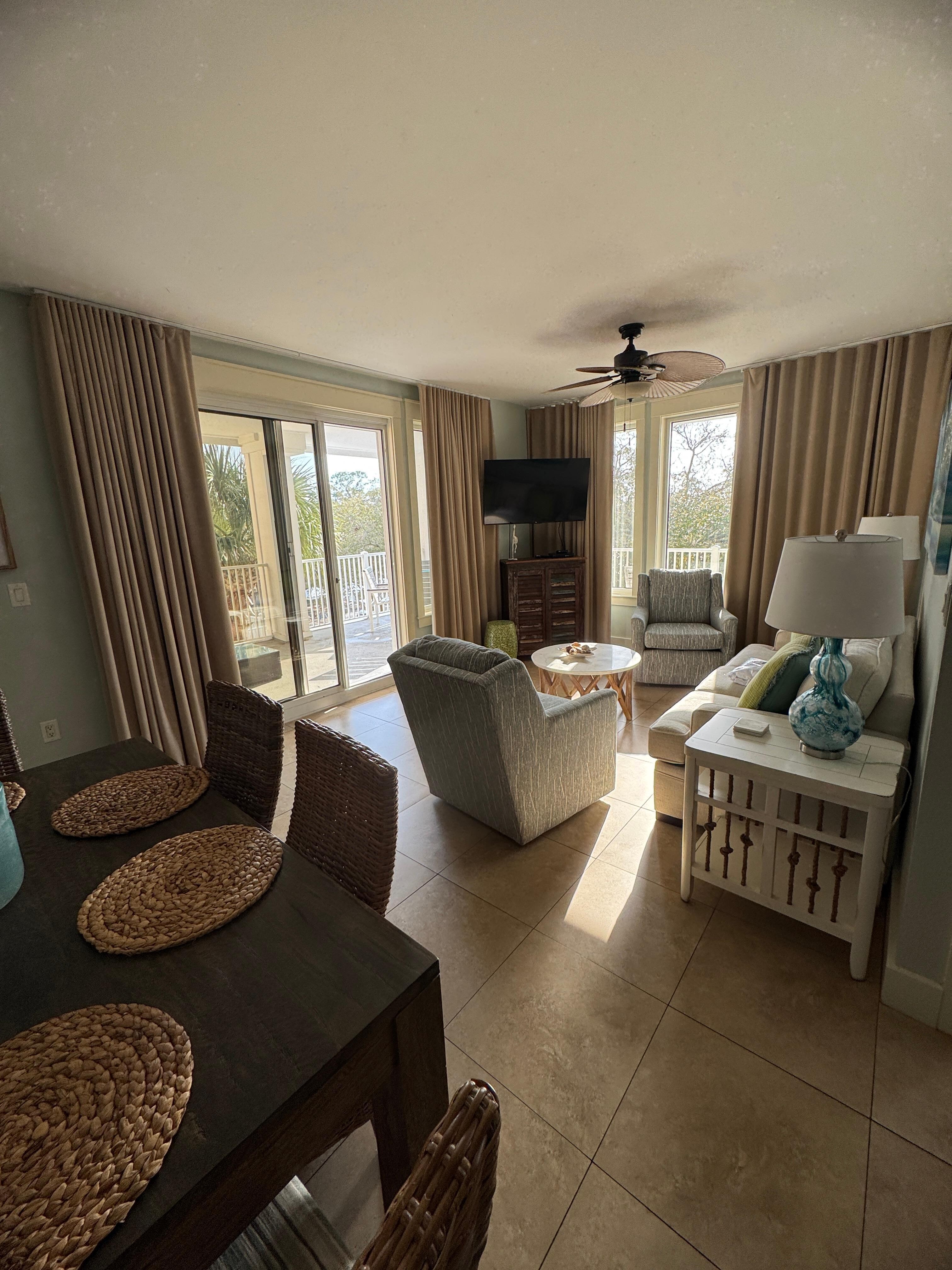 View of living area and partial of dining area from door. 