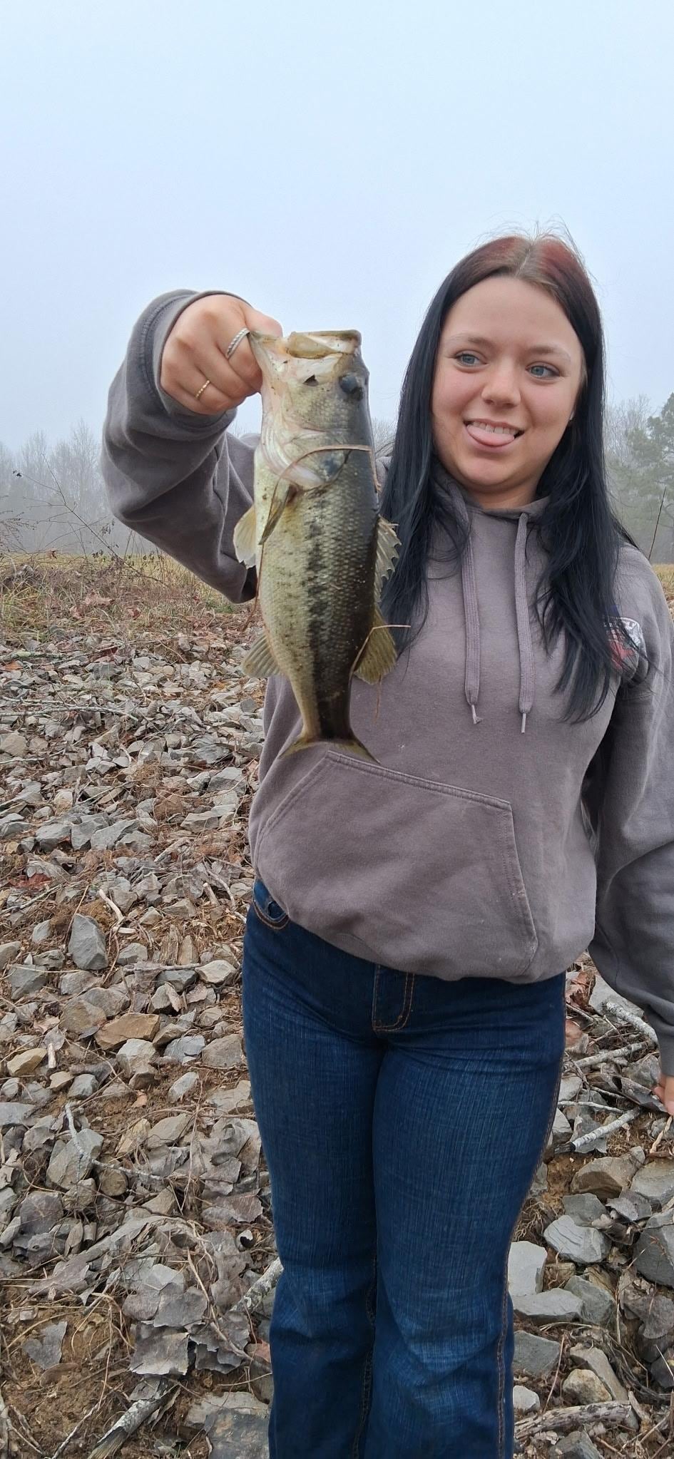 My daughters holding one of the fish my son caught