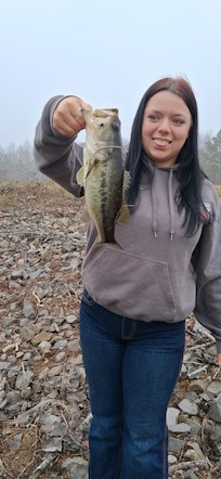 My daughters holding one of the fish my son caught