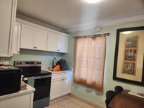 Kitchen view#2 - stove, sink, microwave