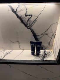 Small travel sized body wash and shampoo for a 7-night stay