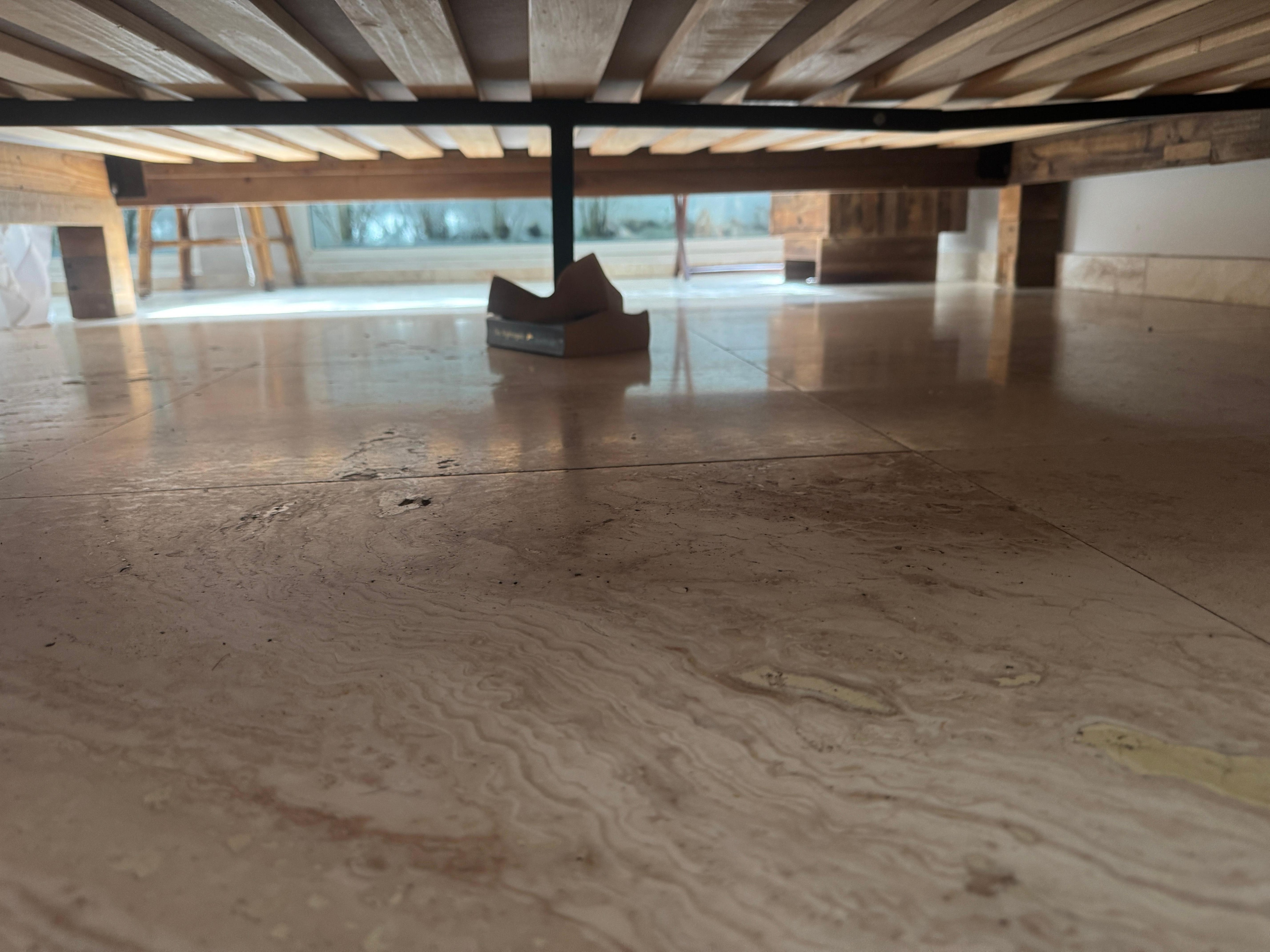 Bed has books under it to keep it stabilized (first bedroom when you walk in house)