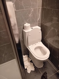 Toilet wedged into bathroom I was not able to sit straight on toilet