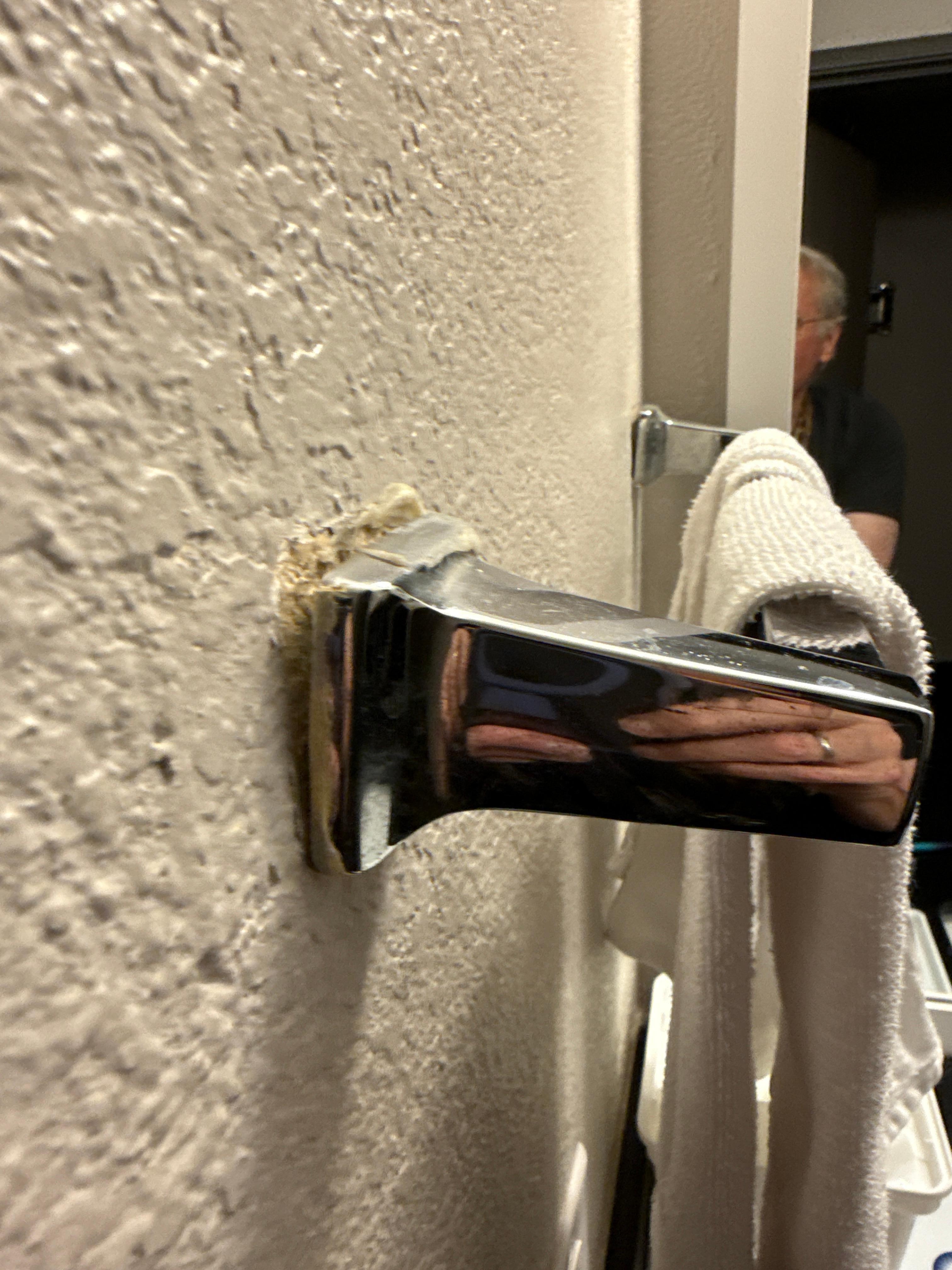 Towel rack about to fall off wall. 