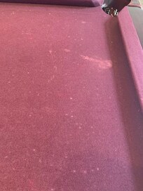 Pool table
has stains all
over the felt,
which is worn
and needs to
be replaced