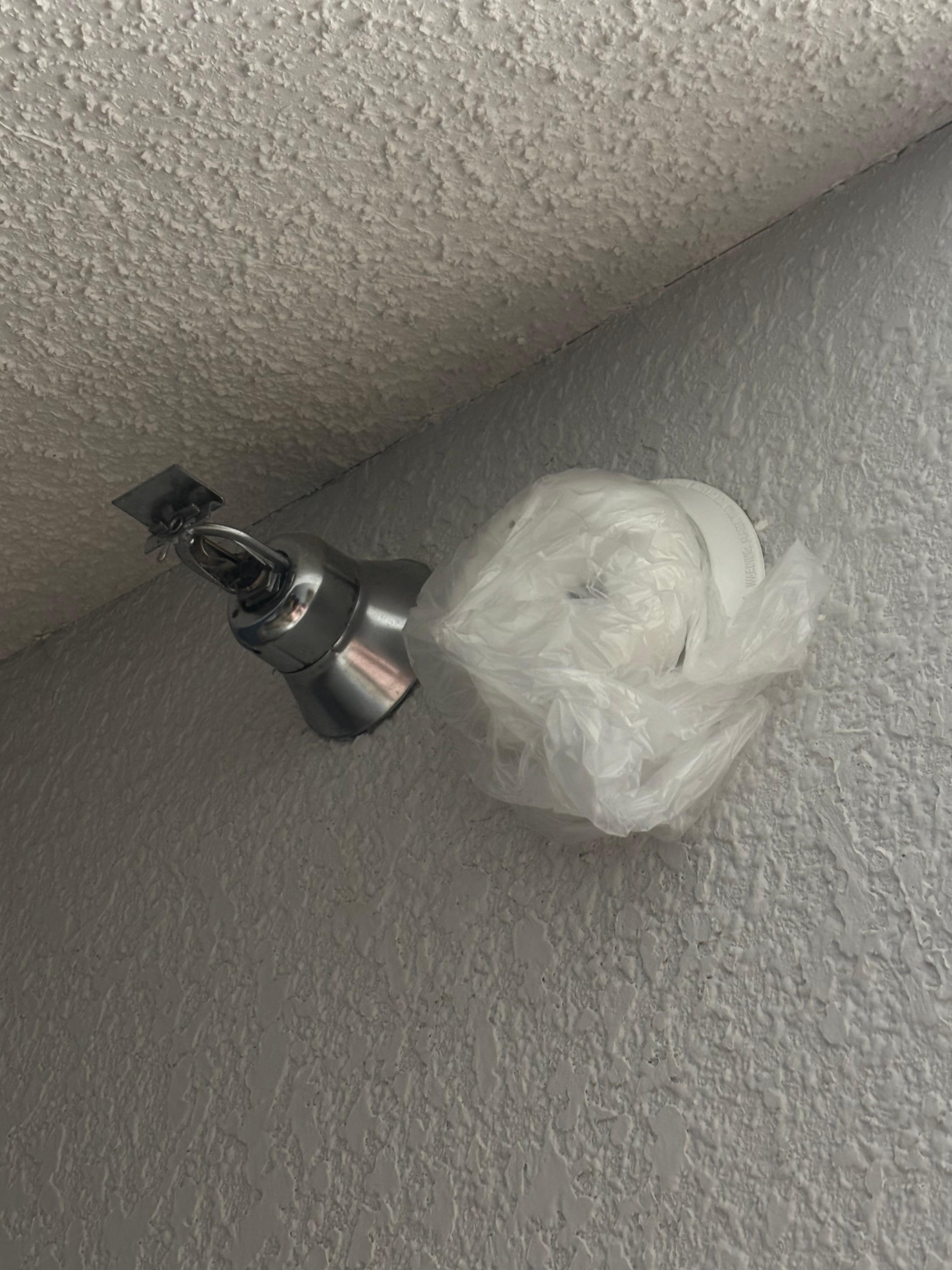 Smoke alarm covered with a bag