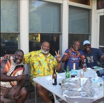 My brothers and God brothers on the deck cooking and drinking .