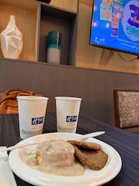 Breakfast of biscuits and gravy and overly dry sausage. Orange juice and water.