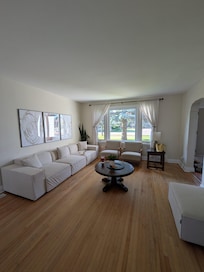 Spacious living room with TV and fireplace