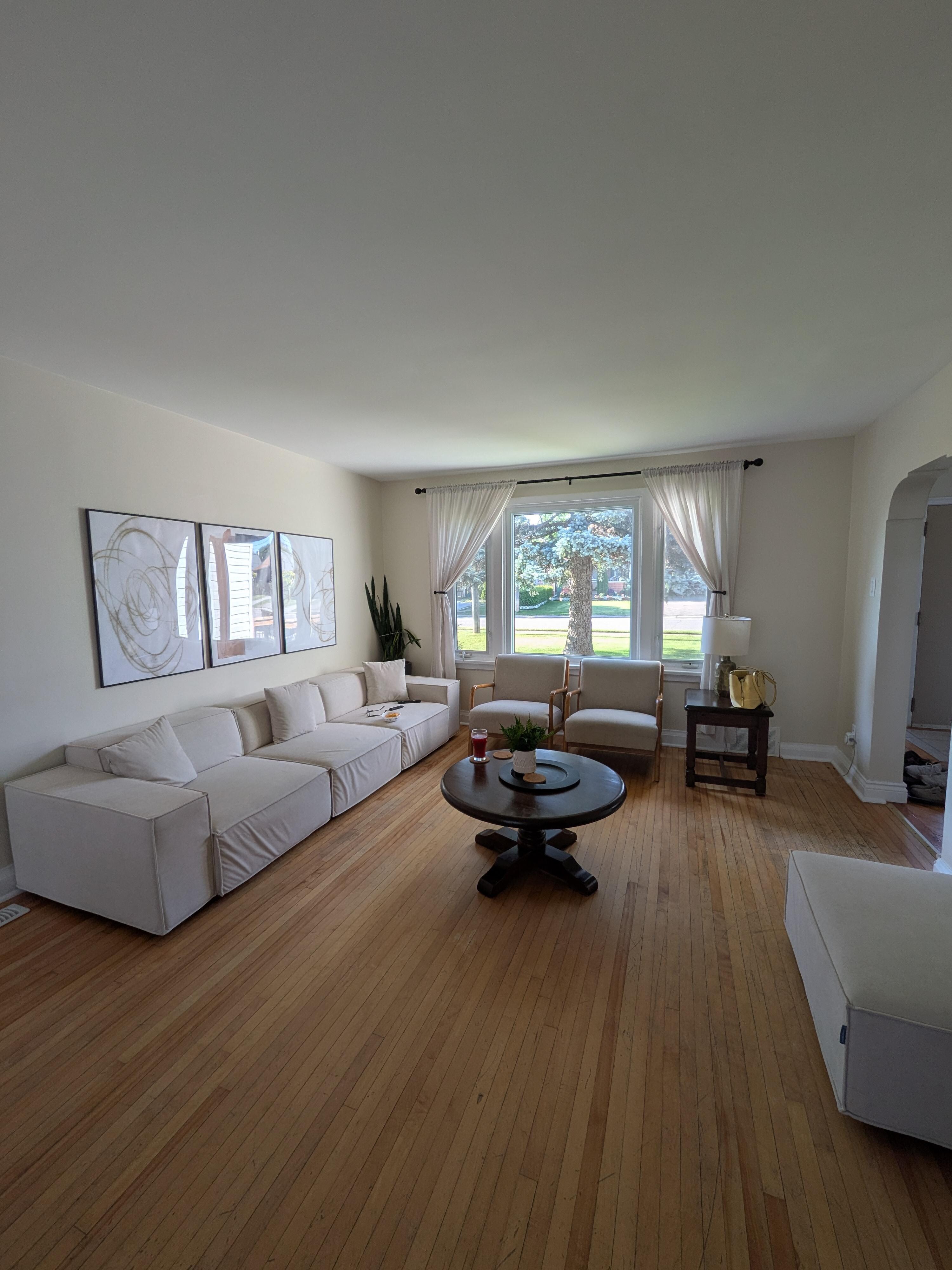 Spacious living room with TV and fireplace