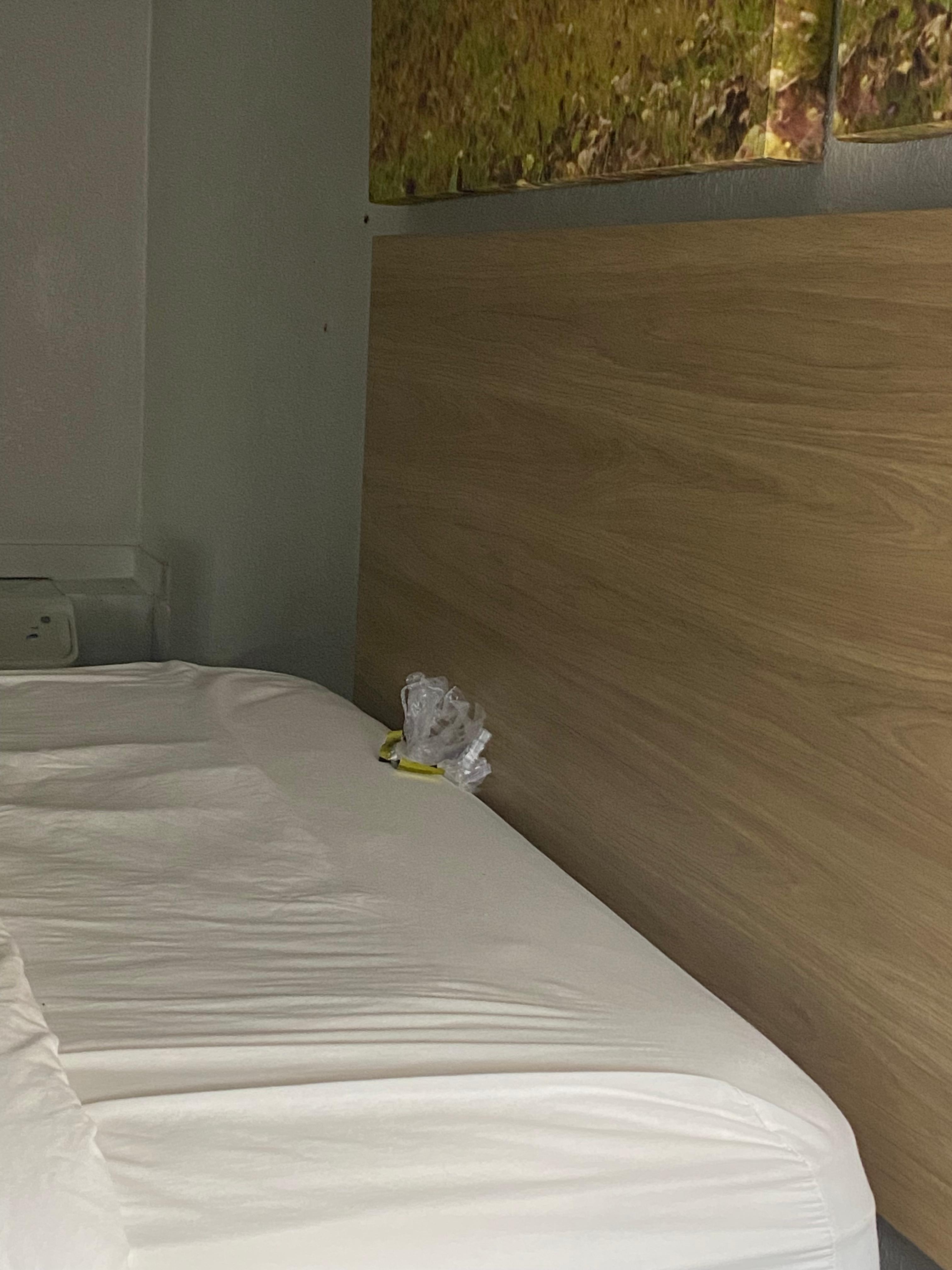 Gold condom wrapper under pillows