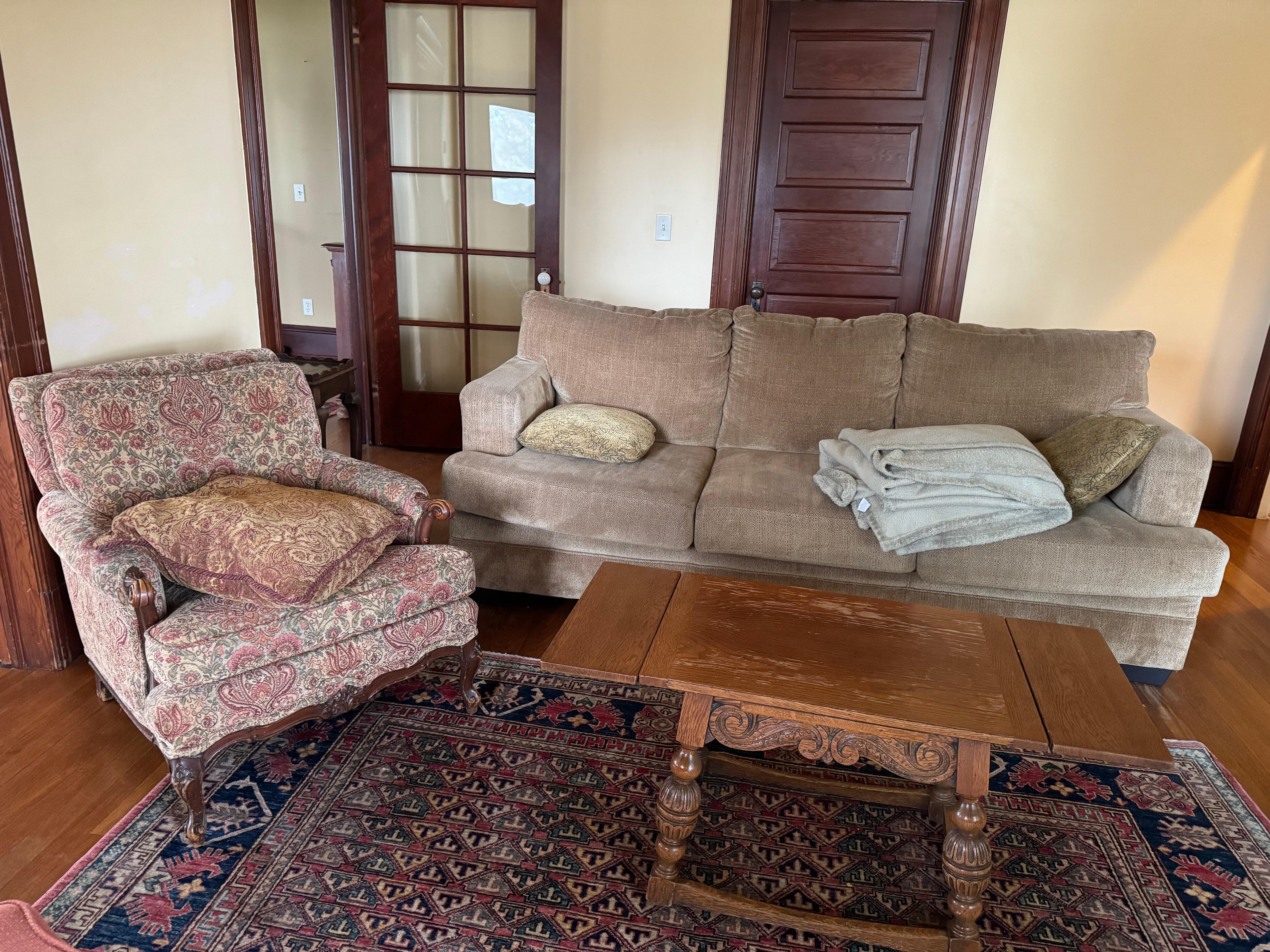 Main living space has weird seating. Tired couch and a bunch of individual chairs all well worn. For this size house, should have a more comfortable main seating area for a group to use. 