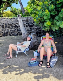 Shady beach with lava tide pools across the street