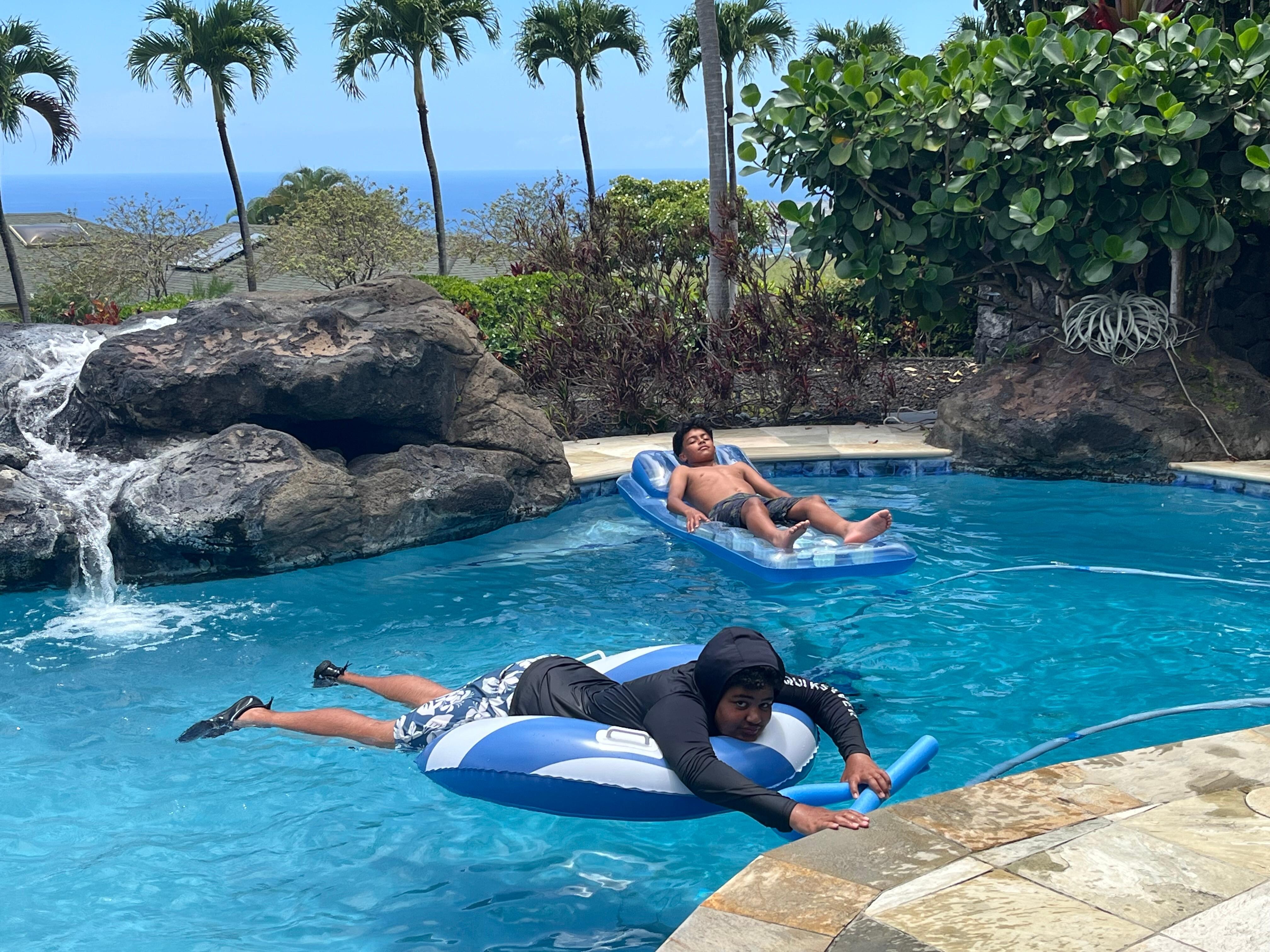Boys relaxing in the pool.