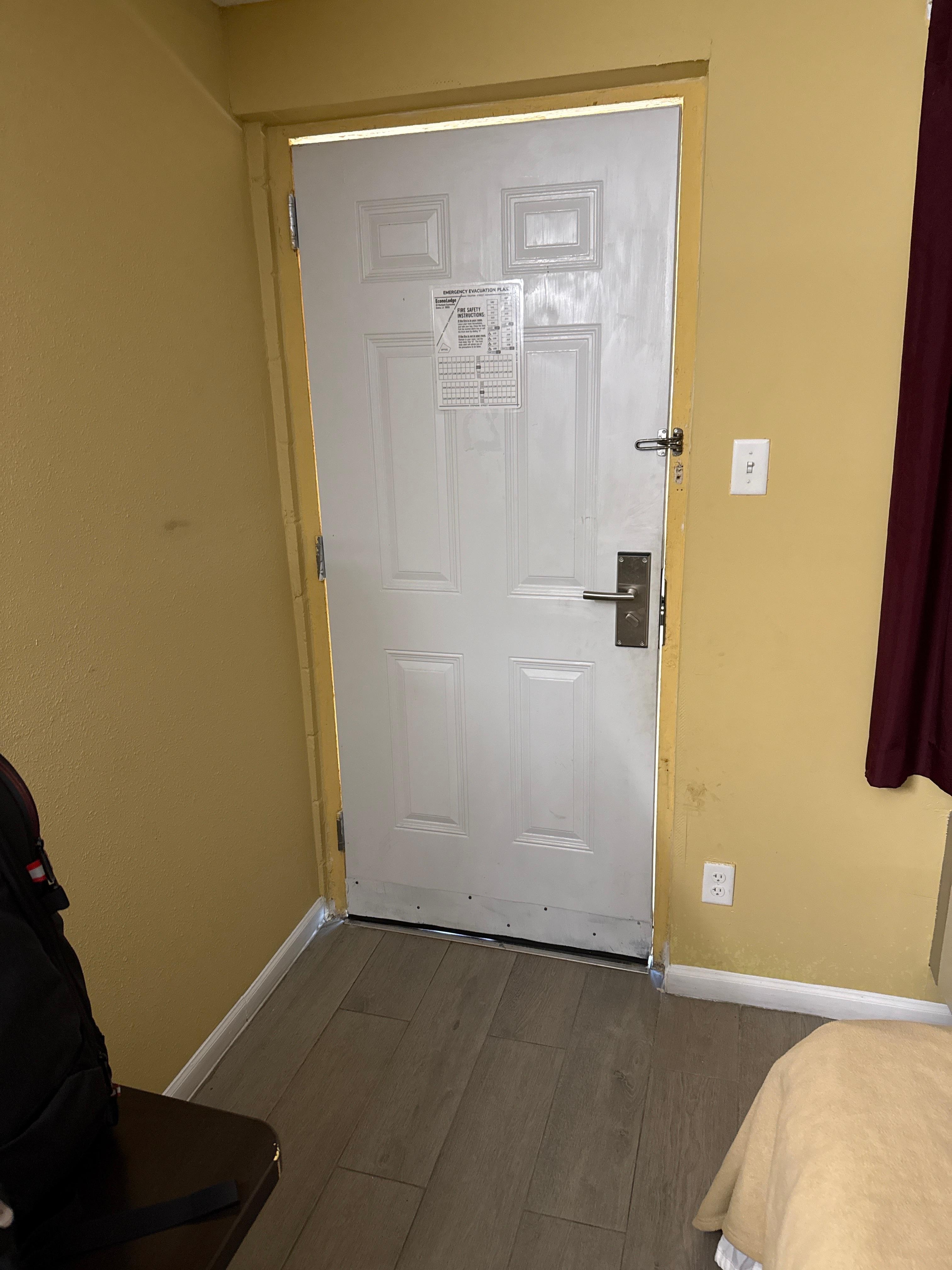 Note the daylight around the door and bent hinges. Also see the dirt on the door and walls.  I had sent this to a friend joking about whether I should feel safe, not intending it for a review. I guess I should have taken more