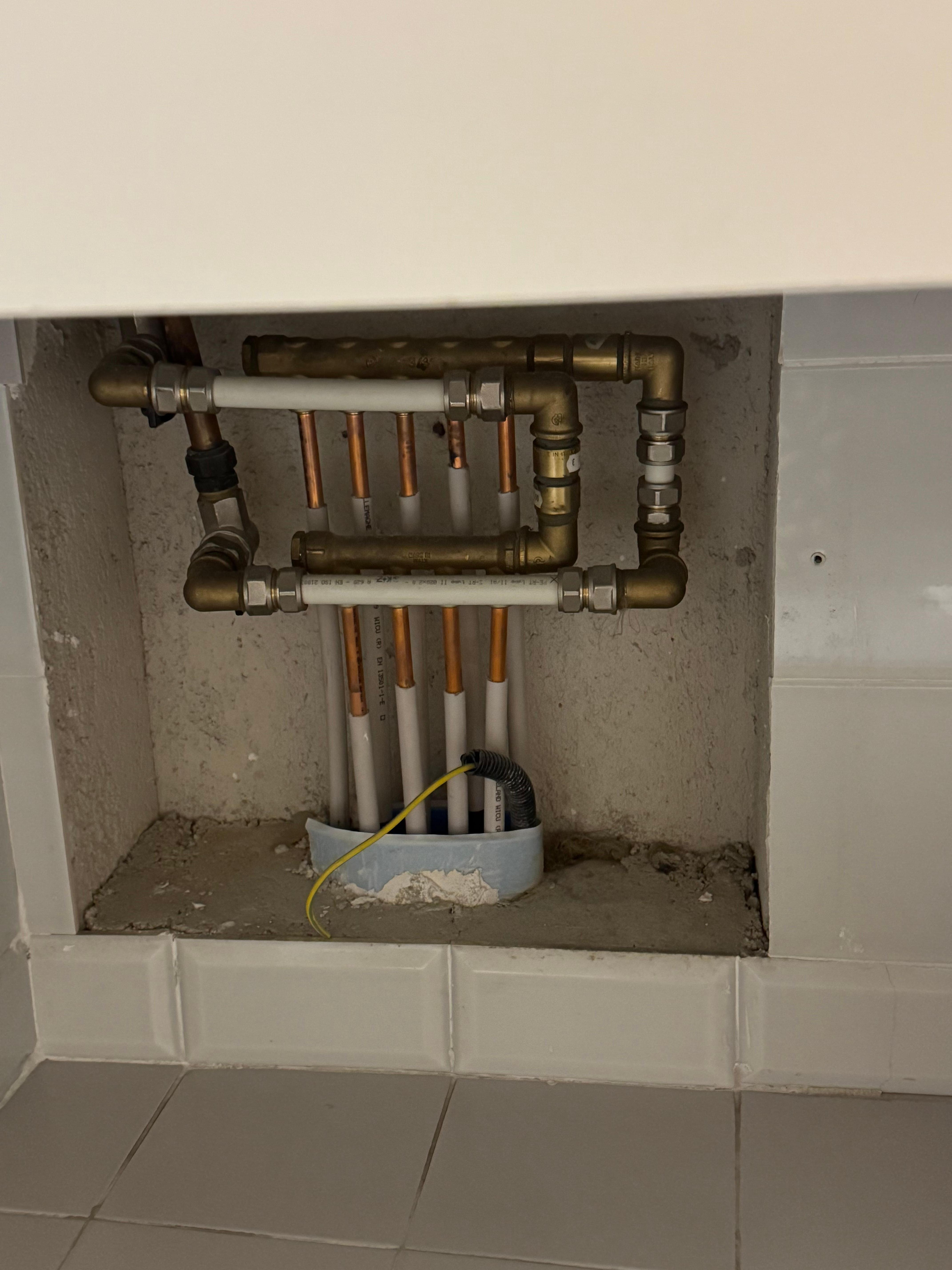 Exposed pipes under the bathroom sink
