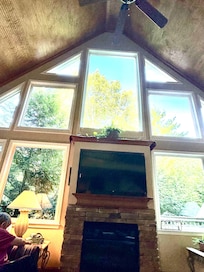 This is the beautiful view of the fireplace and surrounding windows.