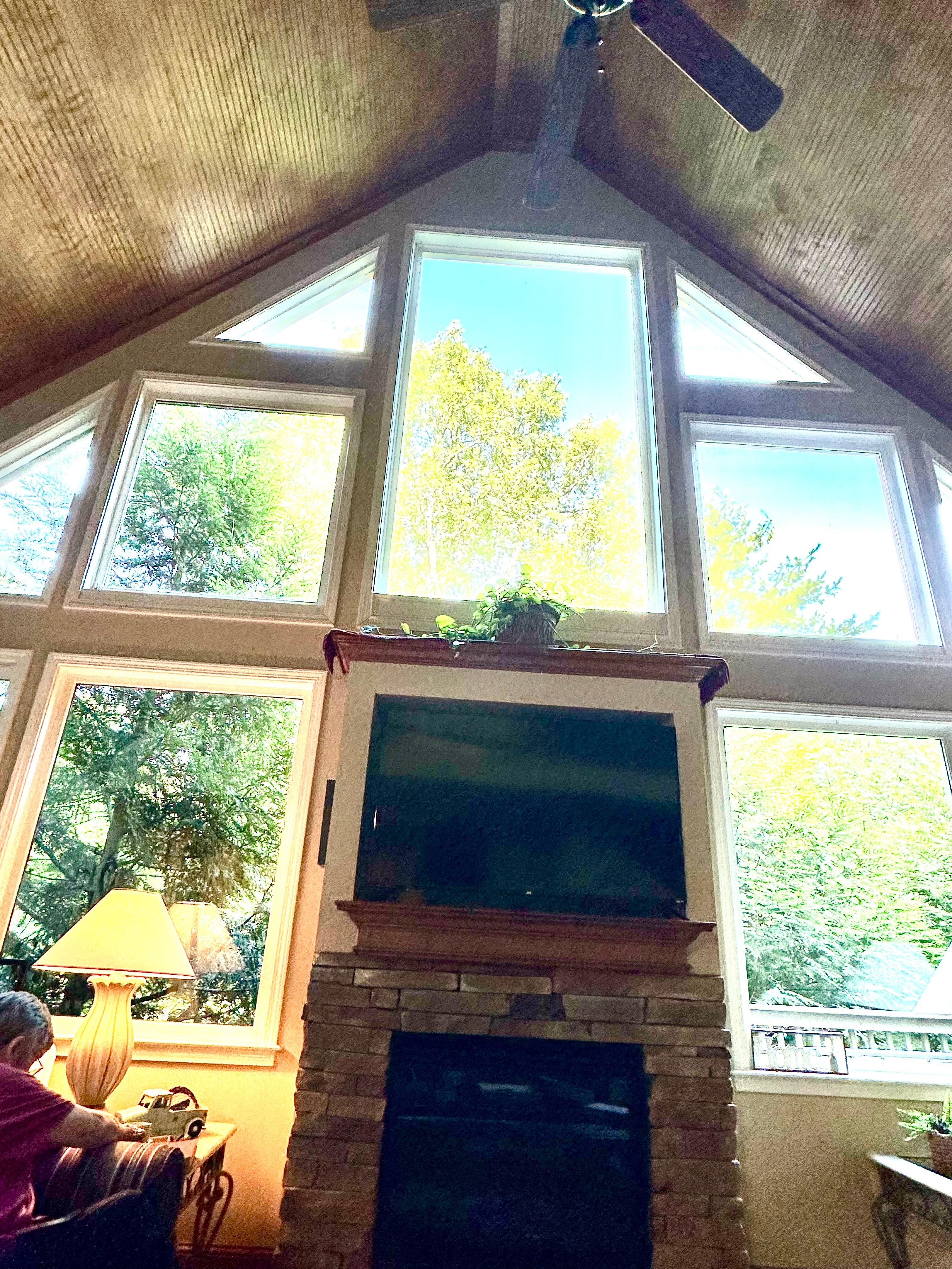 This is the beautiful  view of the fireplace and surrounding windows. 
