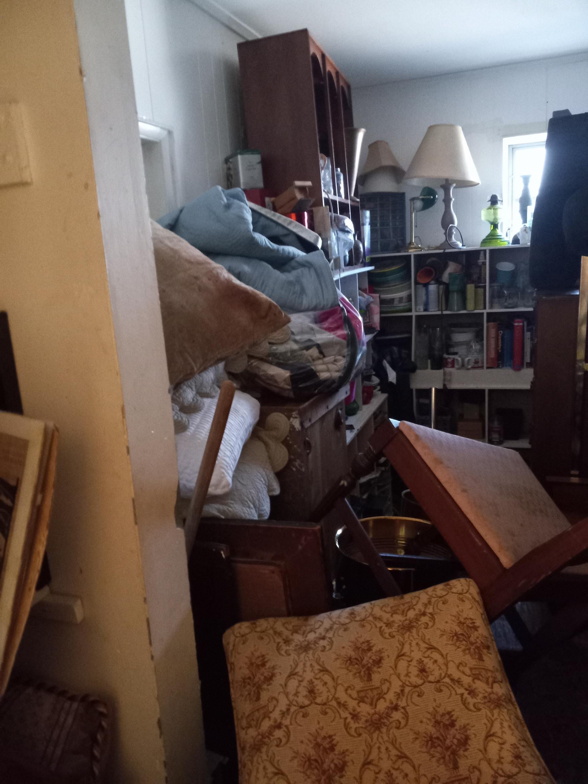 Room with furniture packed to the ceiling.