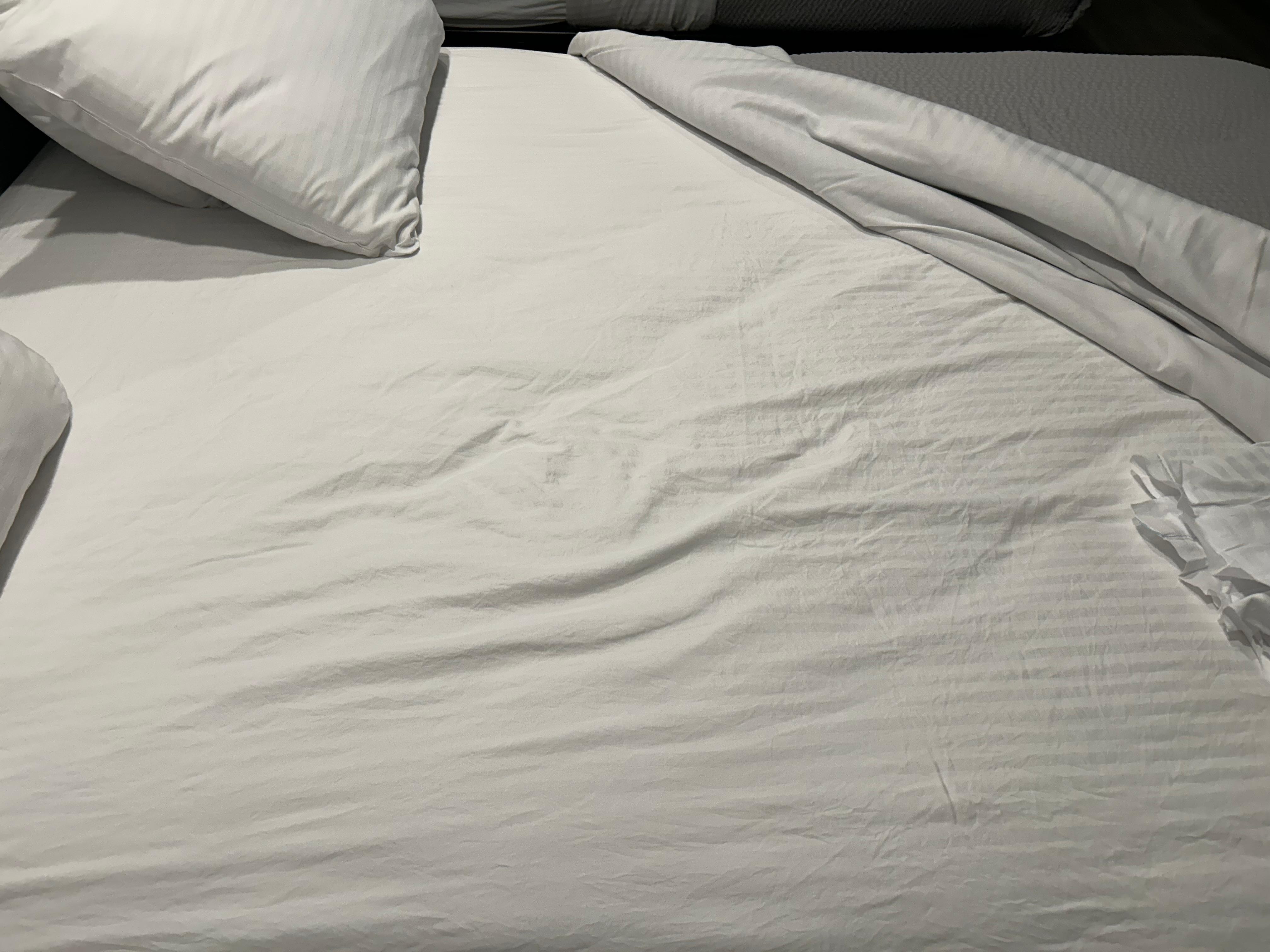 Pulled back covers and sheets were obviously slept in and not changed. Body and butt print.