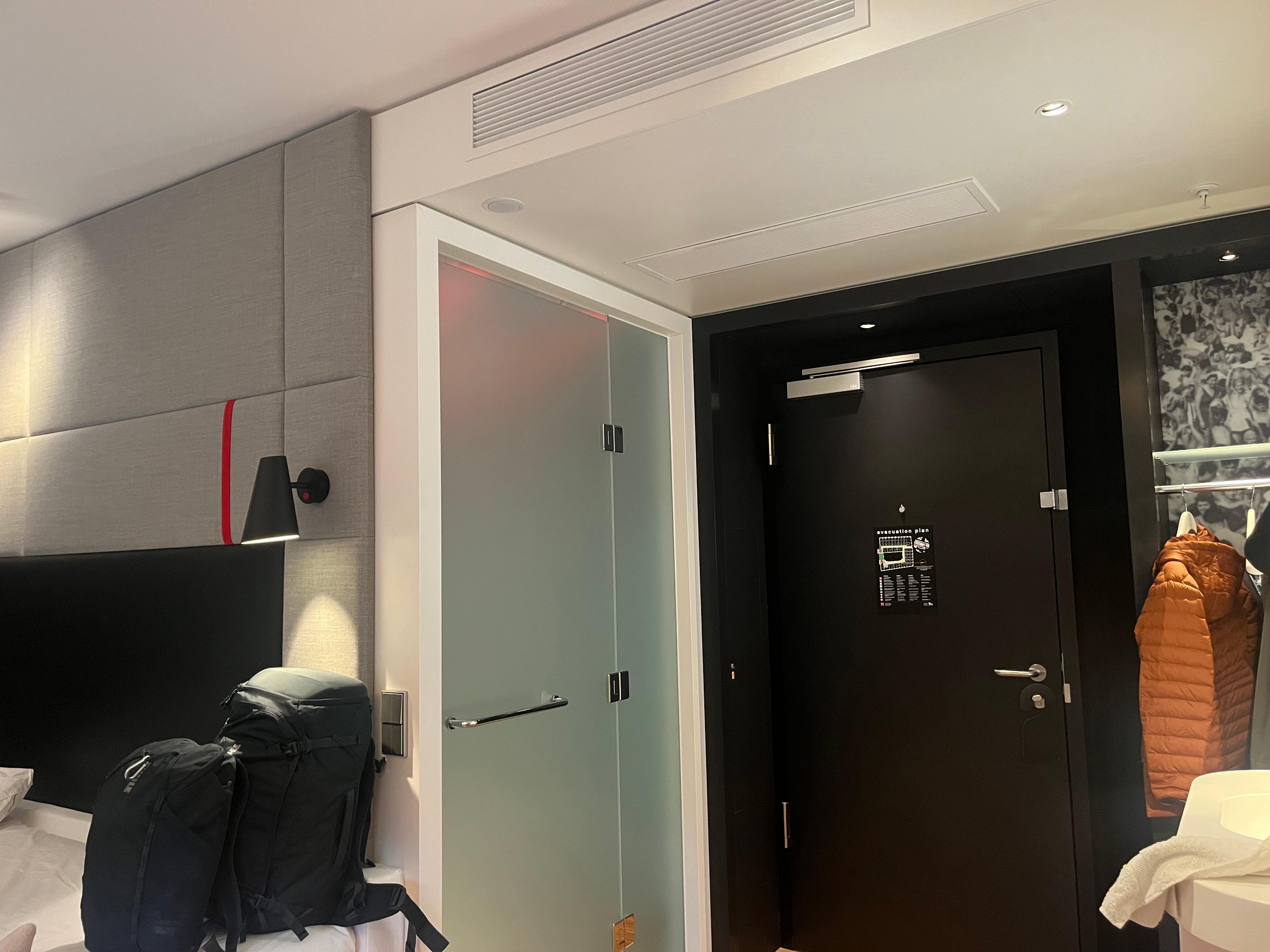 Bathroom on left with glass door.