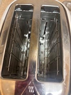Toaster had burnt on grease and crumbs inside.