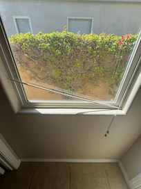 Window with broken rod left across bottom.