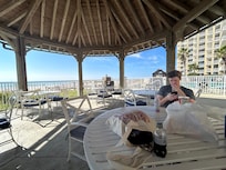Taking a break from the sun under a large gazebo.