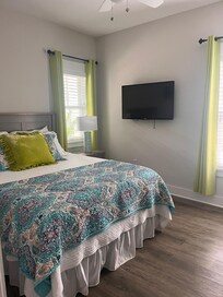 Beautiful bedroom w thoughtful ironing board, hangers, extra pillows, blankets, etc