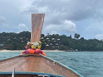 Longboat ride with rooms in the background. Maybe 15 min ride.