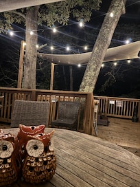 The beautiful outside deck. Lights on at night. Amazing hot tub.