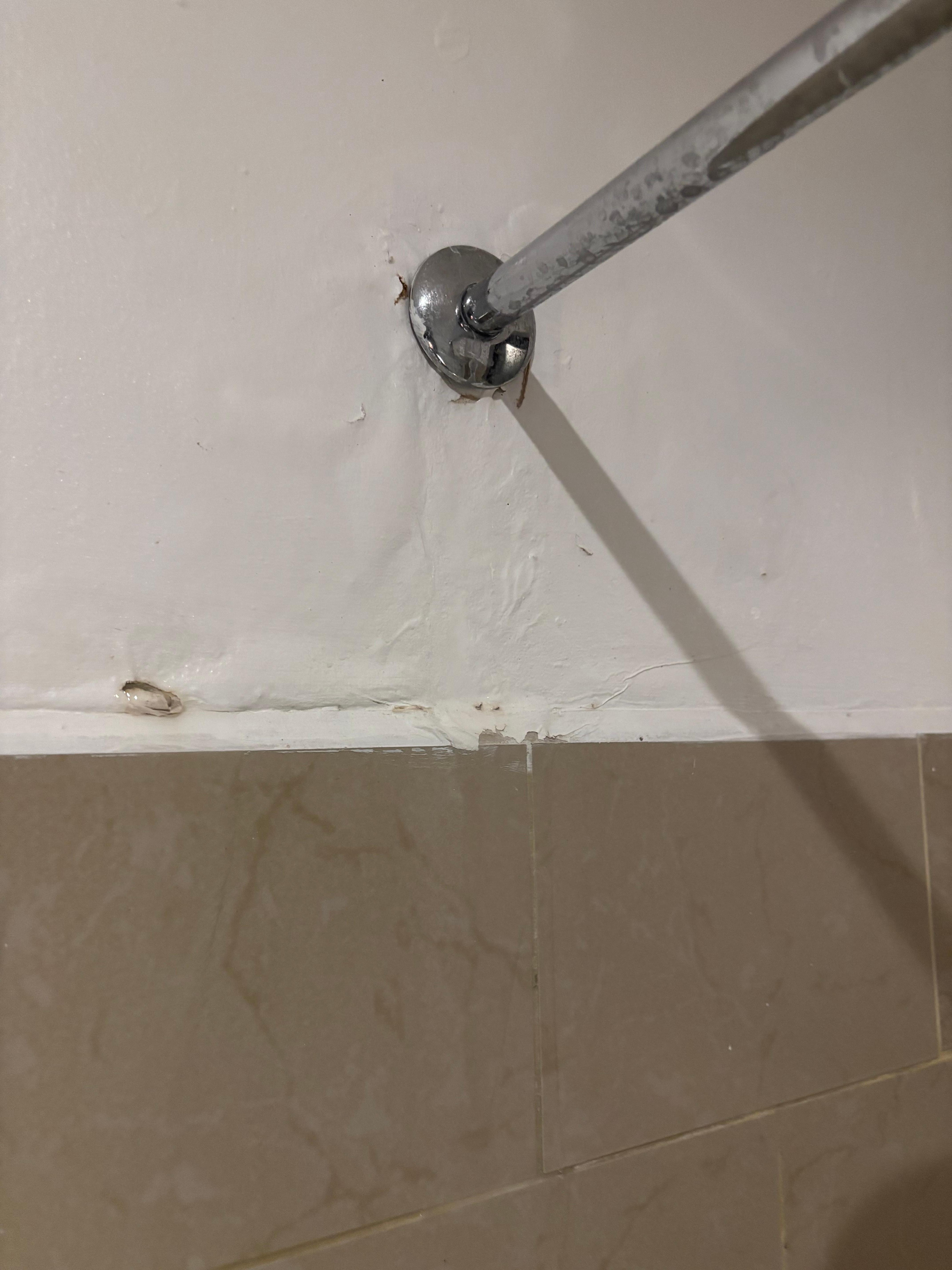 Water pours out of the wall when the shower is on. This is the other side of the wall pictured above.)